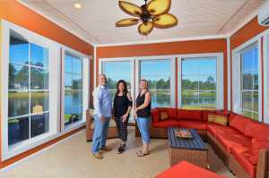 Tom Suriano ( left )with his wife Paula Suriano (middle) & homeowner Elise Zebrowski (right) in the sunroom of the Zebrowski residence.